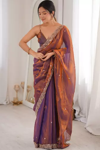 Rust tissue satin embroidered saree with unstitched blouse piece.