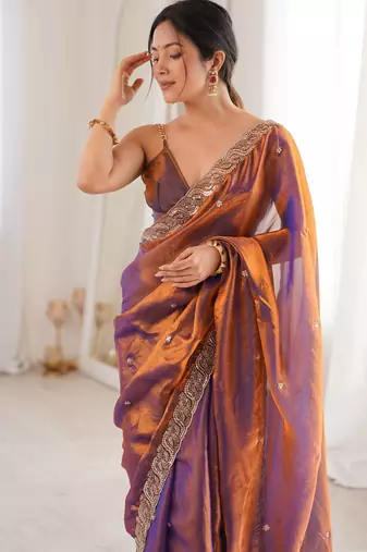 Rust tissue satin embroidered saree with unstitched blouse piece.