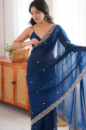 Teal tissue satin embroidered saree with unstitched blouse piece.