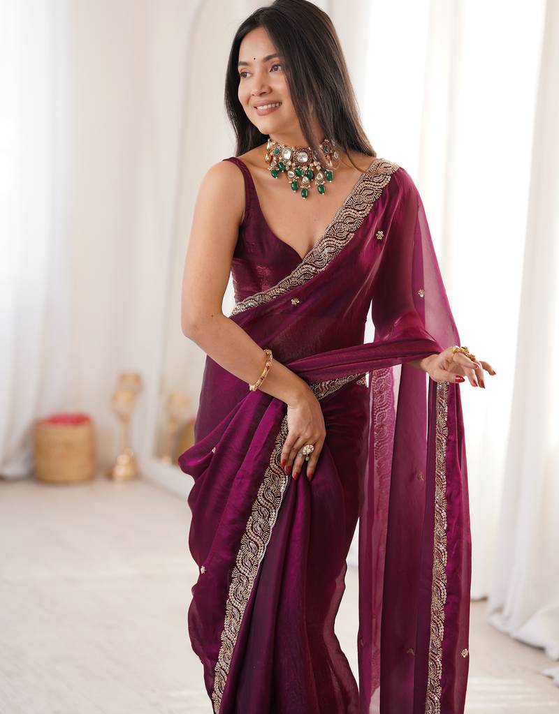 Wine tissue satin embroidered saree with unstitched blouse piece.