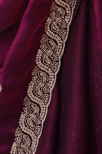 Wine tissue satin embroidered saree with unstitched blouse piece.