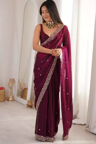 Wine tissue satin embroidered saree with unstitched blouse piece.