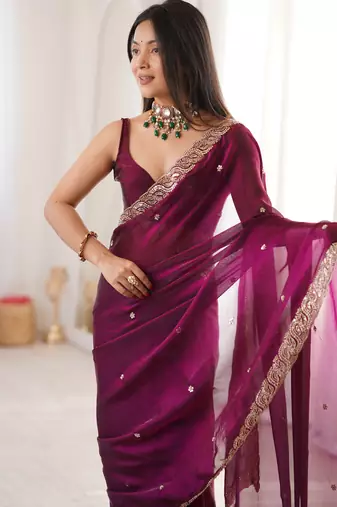 Wine tissue satin embroidered saree with unstitched blouse piece.