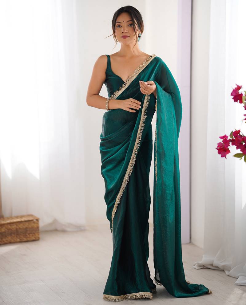 Green tissue satin sequins saree with unstitched blouse piece.