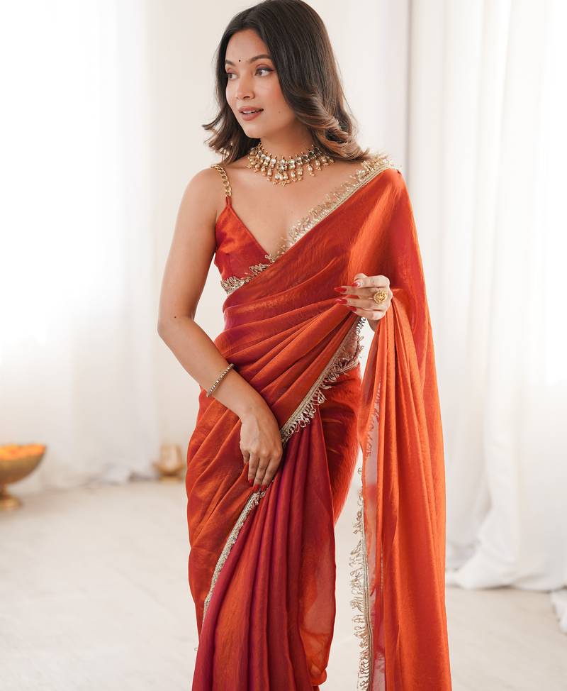 Orange tissue satin sequins saree with unstitched blouse piece.