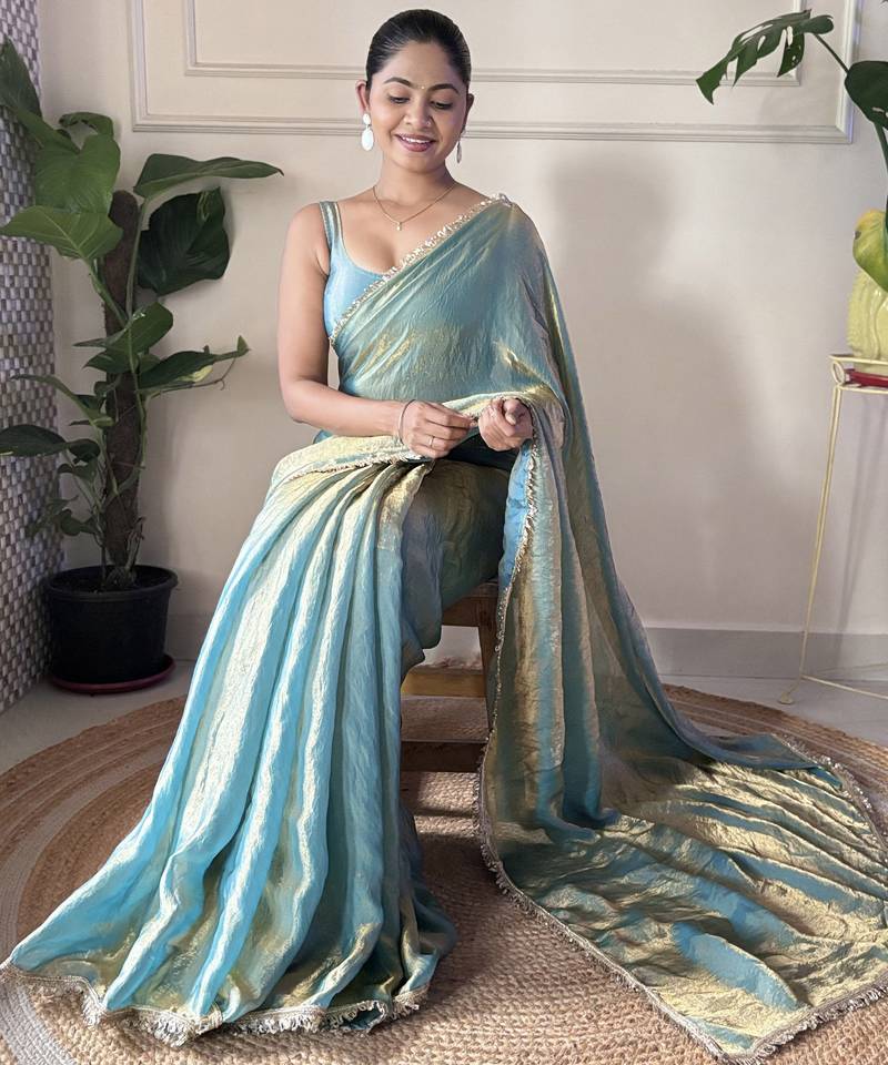 Sky blue tissue satin sequins saree with unstitched blouse piece.