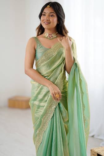 Green tissue satin sequins saree with unstitched blouse piece.
