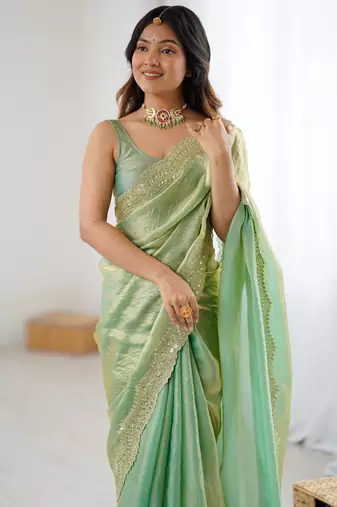 Green tissue satin sequins saree with unstitched blouse piece.