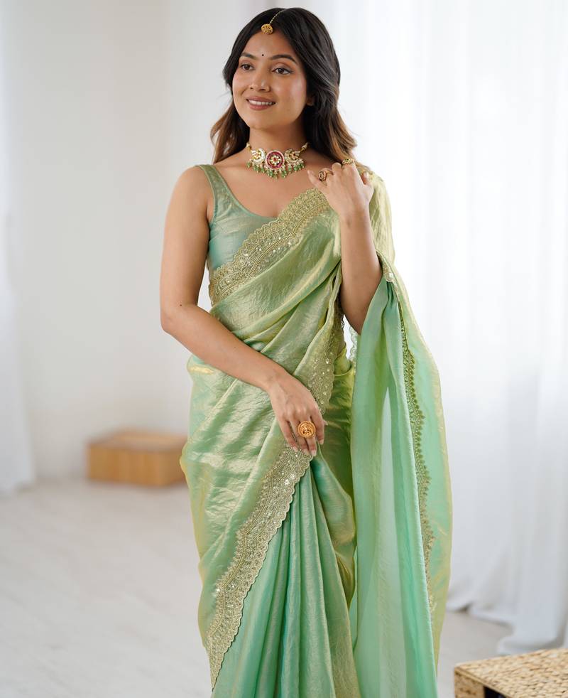 Green tissue satin sequins saree with unstitched blouse piece.