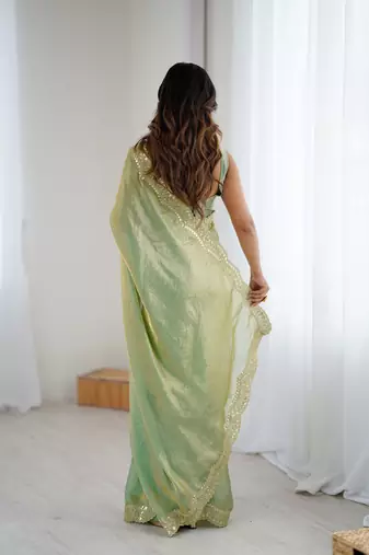 Green tissue satin sequins saree with unstitched blouse piece.