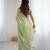 Green tissue satin sequins saree with unstitched blouse piece.