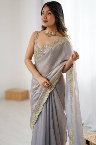 Grey tissue satin sequins saree with unstitched blouse piece.