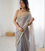 Grey tissue satin sequins saree with unstitched blouse piece.
