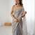 Grey tissue satin sequins saree with unstitched blouse piece.