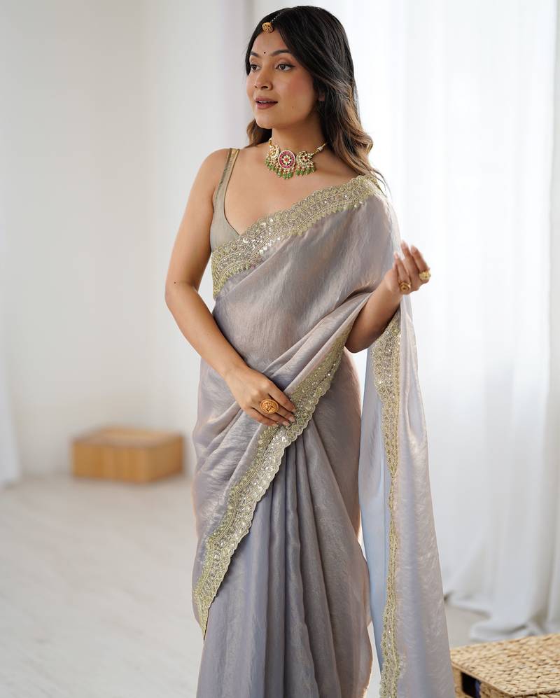 Grey tissue satin sequins saree with unstitched blouse piece.