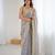 Grey tissue satin sequins saree with unstitched blouse piece.