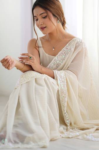 Cream georgette sequins saree with unstitched blouse piece.