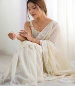 Cream georgette sequins saree with unstitched blouse piece.