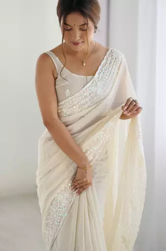 Cream georgette sequins saree with unstitched blouse piece.