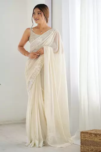 Cream georgette sequins saree with unstitched blouse piece.