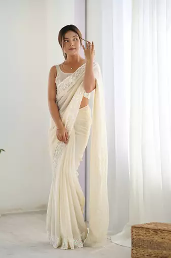 Cream georgette sequins saree with unstitched blouse piece.