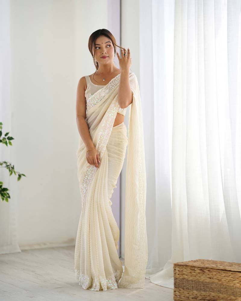 Cream georgette sequins saree with unstitched blouse piece.
