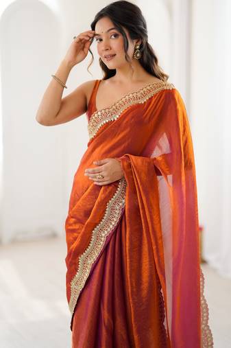 Orange tissue satin sequins saree with unstitched blouse piece.