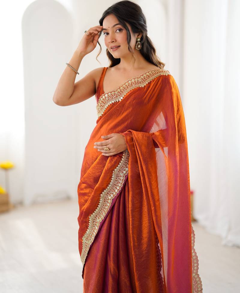 Orange tissue satin sequins saree with unstitched blouse piece.