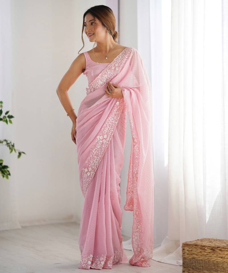 Pink georgette sequins saree with unstitched blouse piece.