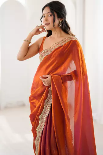 Orange tissue satin sequins saree with unstitched blouse piece.