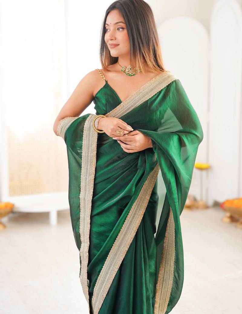 Green tissue satin solid saree with unstitched blouse piece.