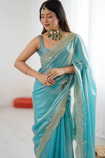 Sky blue tissue satin sequins saree with unstitched blouse piece.