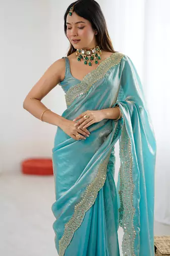 Sky blue tissue satin sequins saree with unstitched blouse piece.