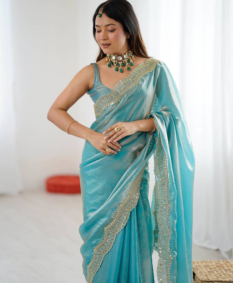 Sky blue tissue satin sequins saree with unstitched blouse piece.