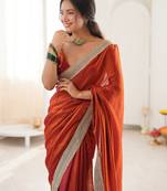Oeange tissue satin solid saree with unstitched blouse piece.