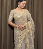 Beige tissue satin embroidered saree with unstitched blouse piece.