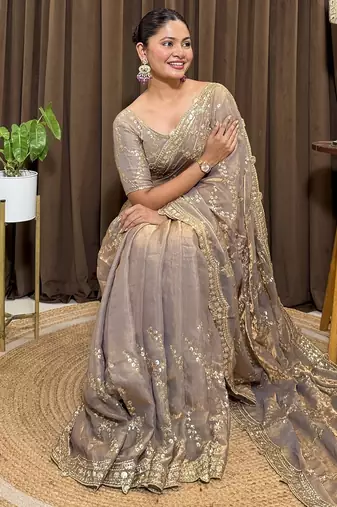 Beige tissue satin embroidered saree with unstitched blouse piece.