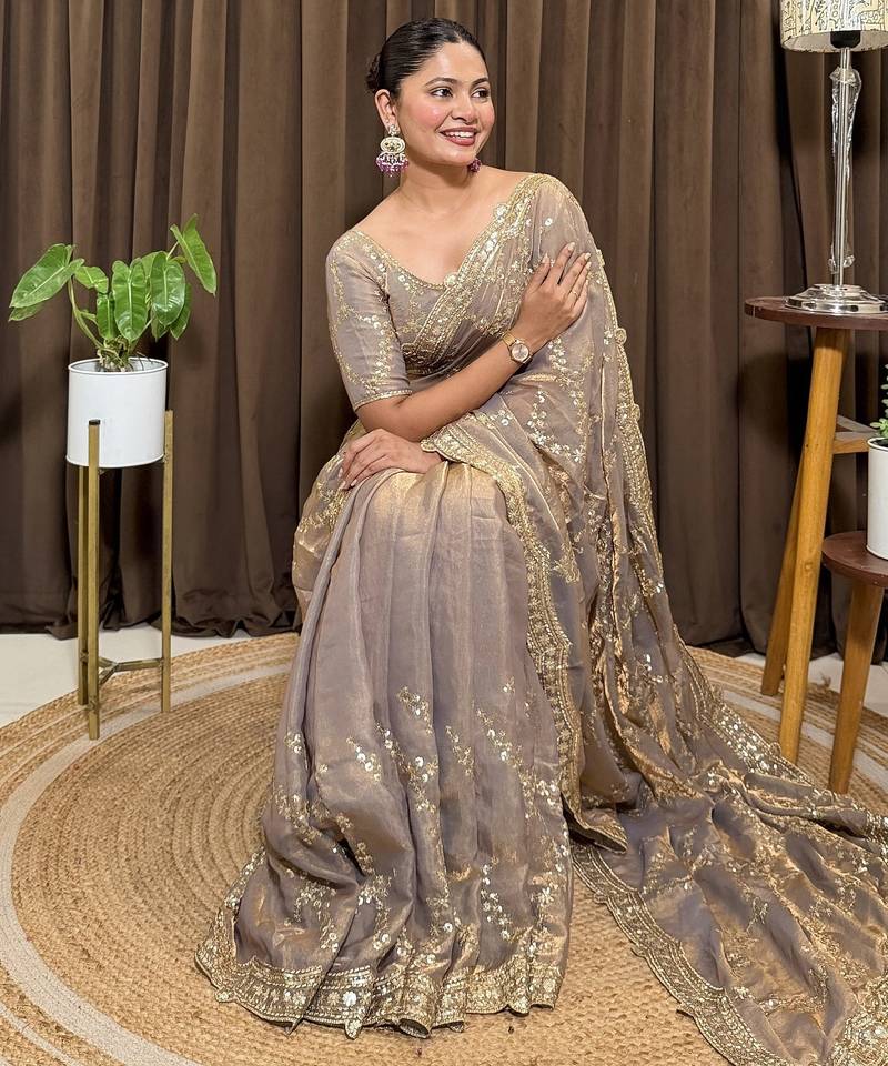 Beige tissue satin embroidered saree with unstitched blouse piece.