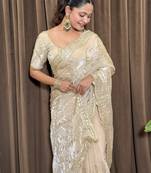 Cream tissue satin embroidered saree with unstitched blouse piece.