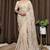 Cream tissue satin embroidered saree with unstitched blouse piece.