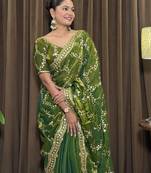 Green tissue satin embroidered saree with unstitched blouse piece.