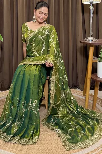 Green tissue satin embroidered saree with unstitched blouse piece.