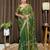 Green tissue satin embroidered saree with unstitched blouse piece.