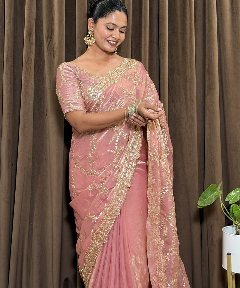 Pink tissue satin embroidered saree with unstitched blouse piece.