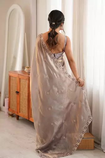 Grey tissue satin embroidered saree with unstitched blouse piece.
