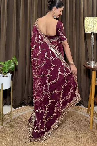 Wine tissue satin embroidered saree with unstitched blouse piece.