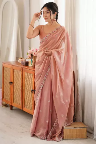 Peach tissue satin embroidered saree with unstitched blouse piece.