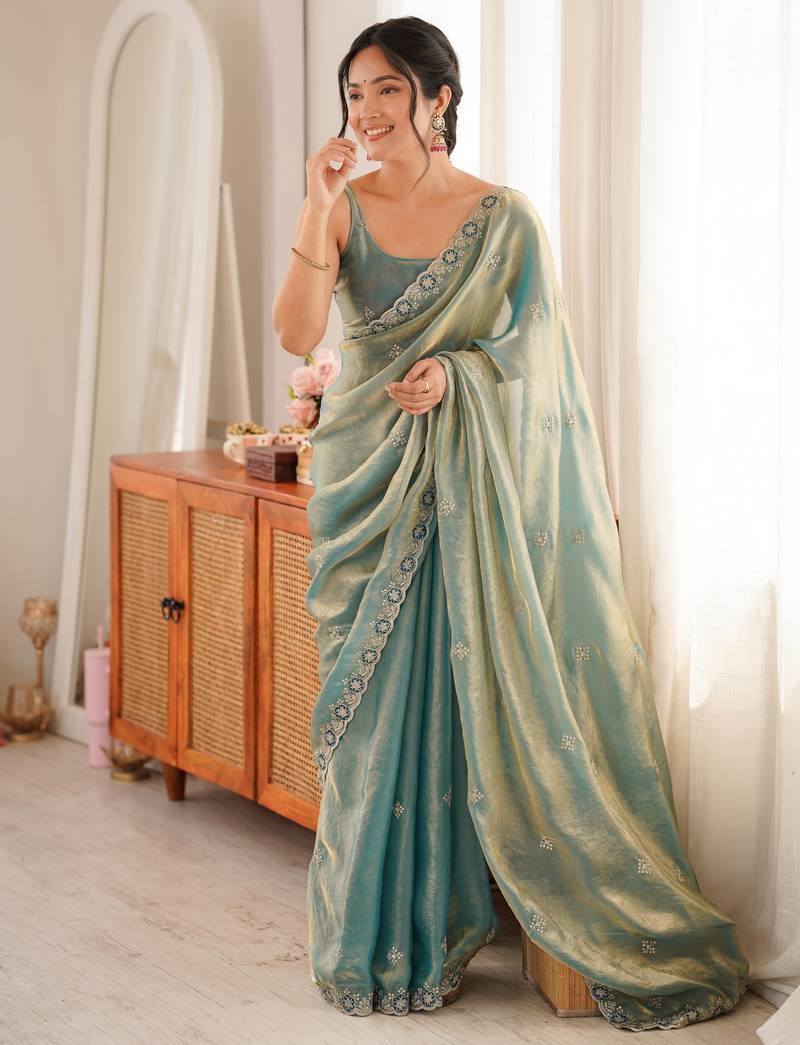 Sky blue tissue satin embroidered saree with unstitched blouse piece.