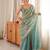 Sky blue tissue satin embroidered saree with unstitched blouse piece.