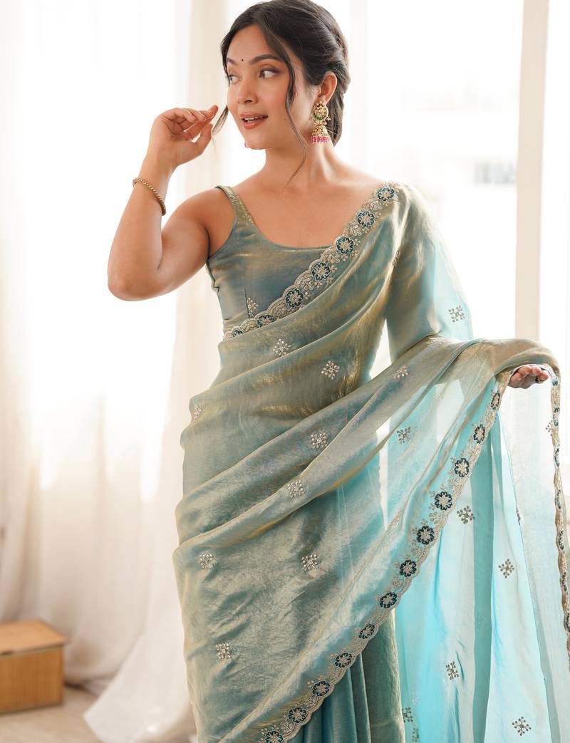 Sky blue tissue satin embroidered saree with unstitched blouse piece.